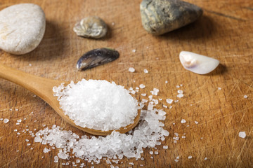 Fototapeta na wymiar Close up of sea salt in wooden spoon