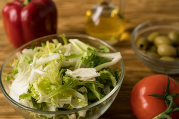 Salad ingridients. Tomato, lettuce, paprika and olive oil.