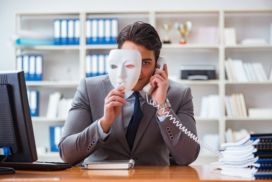 Businessman with mask in office hypocrisy concept