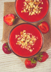 Strawberry smoothie with fresh fruit .