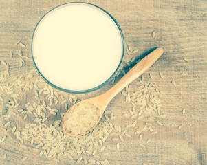 Rice milk on the wooden background .