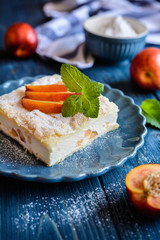 Dessert made of two puff pastry layers filled with mascarpone cream and nectarine