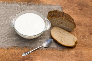 Healthy Breakfast bowl outdoors. Yogurt, seeds, fresh and dried fruits and rye bread.