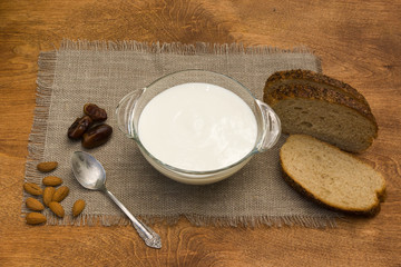 Healthy Breakfast bowl outdoors. Yogurt, seeds, fresh and dried fruits and rye bread.