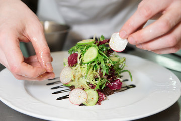 Chef is decorating appetizer