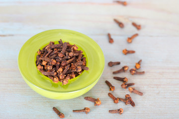 Dry cloves in green bowl. Cloves have Aphrodisiac Properties.