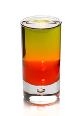 Layered cocktail in shot glass isolated on white