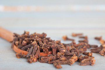 Dry cloves in wooden spoon. Cloves control Diabetes.