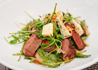 Meat and cheese salad on restaurant table