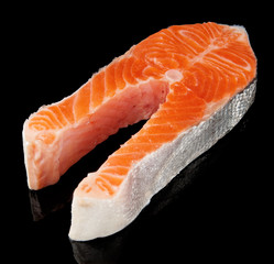 Raw fresh salmon steak isolated on black