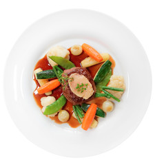 Tenderloin steak with vegetables and bone marrow isolated on white