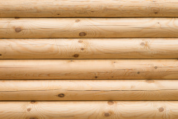 Wooden wall made of logs, backgroud texture
