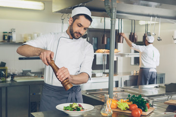  Man japanese restaurant chef cooking in the kitchen