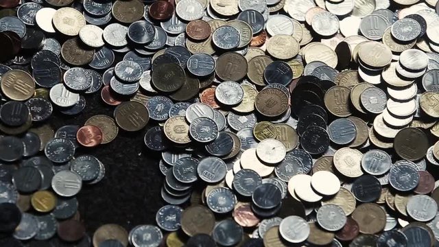 Child plays with Romanian Lei coins