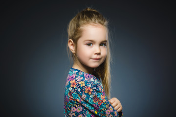Happy girl. Closeup Portrait handsome child smiling isolated on grey