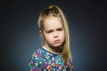 Closeup Thoughtful girl with Hand at head isolated on Gray