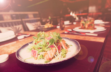 Appetizer with rare fried tuna and salmon, toned