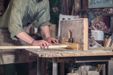 a man working with wood product on the machine