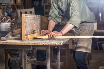 a man working with wood product on the machine
