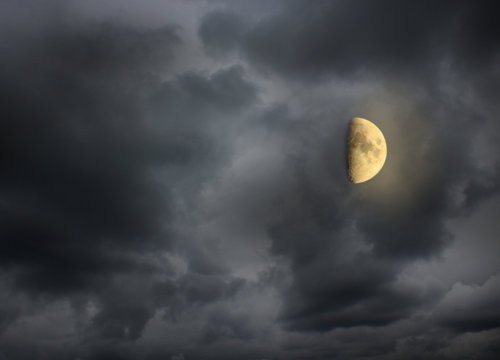 Moon in the night cloudy sky