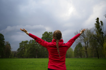Fototapeta na wymiar Hands up woman on nature, sky, green, park, outdoor, healthy lifestyle, standing back