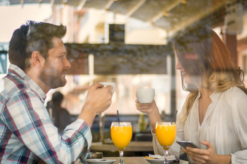 Young couple talking in coffee shop