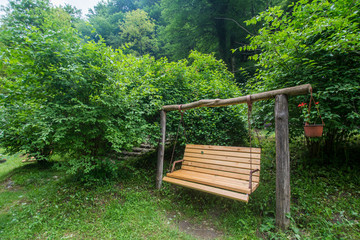 Wooden bench in front of cottage nature house