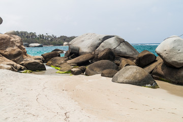 Fototapeta na wymiar Huge boulders on a beach in Tayrona National Park, Colombia