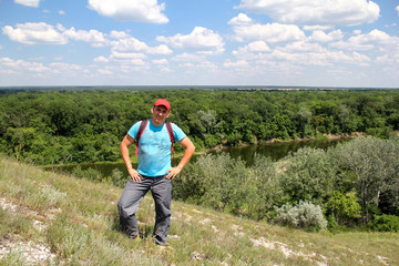 young man climbed a hill over the river