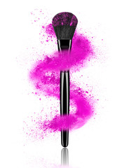 Cosmetic powder whirls around make-up brushes on white background