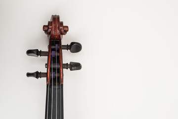 CLose up view of a violin with white plain background.