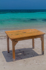 Table on the tropical beach. Mucura island of San Bernardo archipelago, Colombia