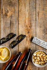 cinema and TV whatching with beer, chips and pop corn wooden background top view mock-up