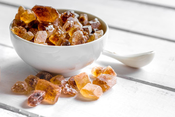 sugar cubes on white wooden table background close up