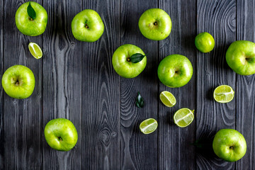 summer food with green apples on dark background top view