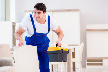 Furniture repairman working in store