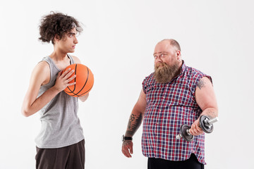 Male hipster showing his strength to friend