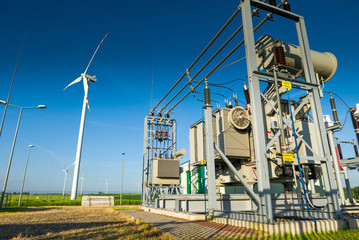 Renewable energy power plant with wind turbines in background