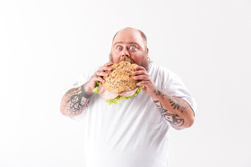 Man eating a large sandwich