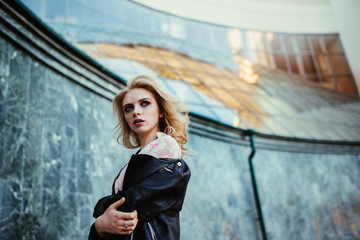 Fashion portrait of young elegant blonde woman outdoors.