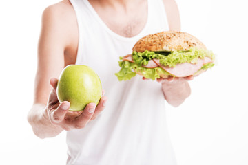 Slim young man making choice in eating