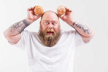 Man playing with donuts