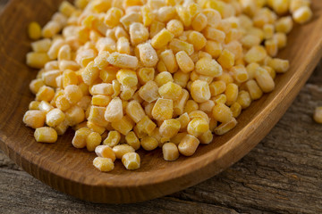 frozen sweet corn on woode surface