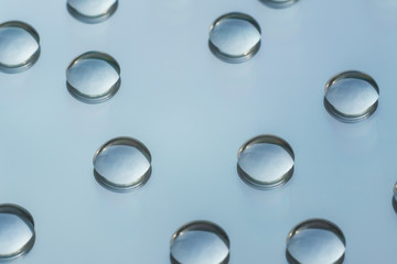 Round drops of water on a glass, close-up background