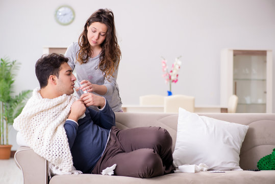 Wife Caring For Sick Husband At Home