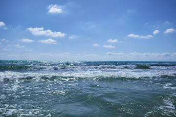 Fototapeta na wymiar The Mediterranean Sea with raging waves on a summer sunny day. Valencia, Alicante, Spain.ean