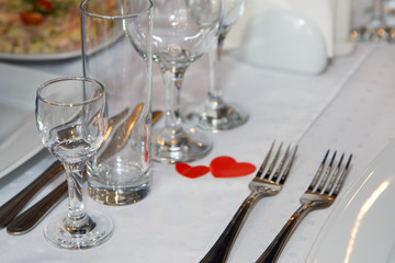 Served with Cutlery table. A Banquet with food and snacks with a luxurious setting on a white tablecloth.