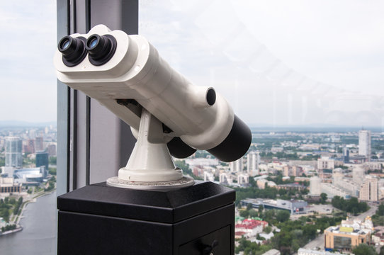 Binoculars on the observation desk on the roof of high building