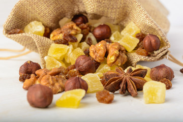 Macro of dried fruits and nuts over white wooden background