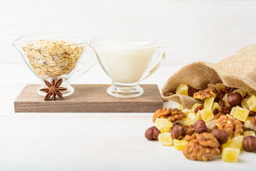 Ingredients with dried fruits, oat flakes and milk